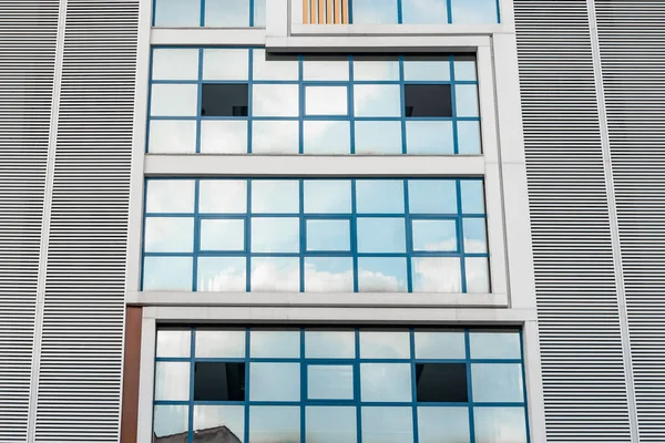 Abstract architectural background, glass facade of a residential building. Low angle view.