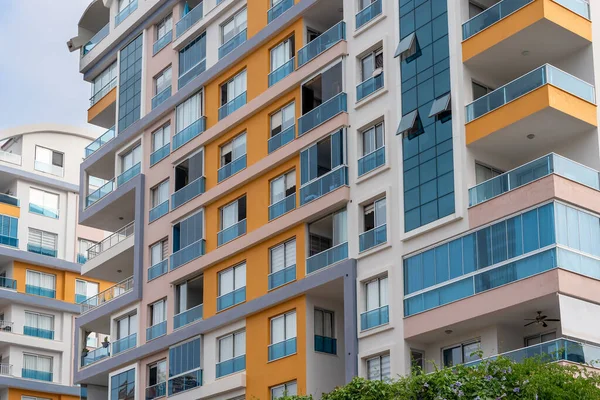 Fragment of a residential building with windows and balconies. Architectural background.