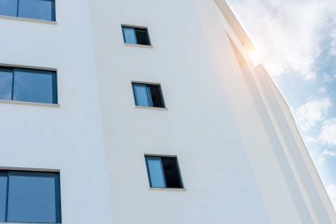 Low angle view of a white apartment building. Residential Properties.