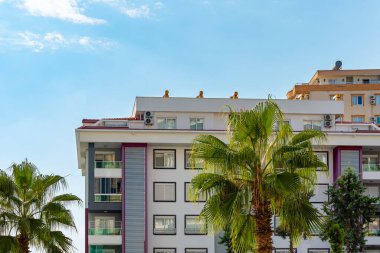 Low angle view of an apartment building with balconies. Residential real estate.