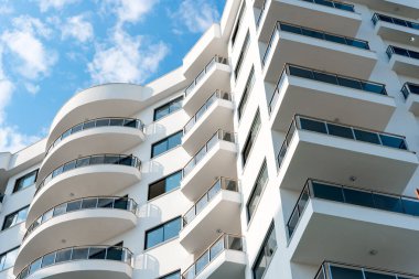 Low angle view of an apartment building with balconies. Residential real estate.
