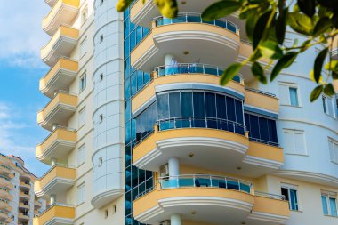 Low angle view of an apartment building with balconies. Residential real estate.