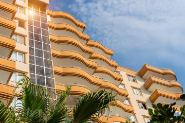 Low angle view of an apartment building with balconies. Residential real estate.