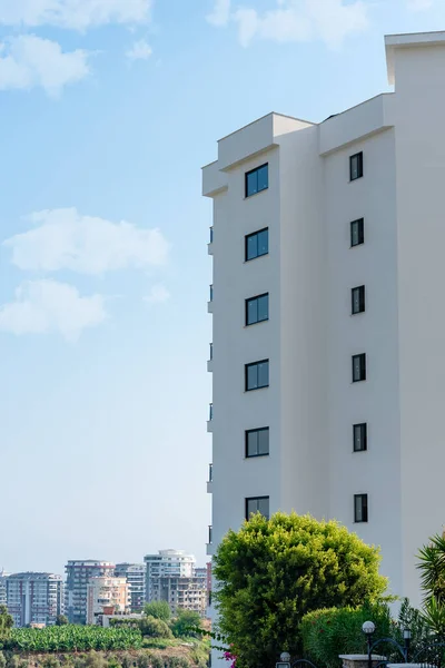 Low angle view of an apartment building with balconies. Residential real estate.