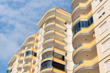Low angle view of an apartment building with balconies. Residential real estate.