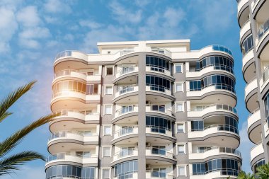 Low angle view of an apartment building with balconies. Residential real estate.