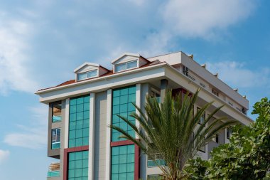Low angle view of an apartment building with balconies. Residential real estate.