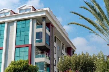 Low angle view of an apartment building with balconies. Residential real estate.