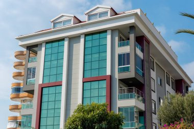 Low angle view of an apartment building with balconies. Residential real estate.