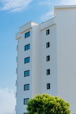 Low angle view of an apartment building with balconies. Residential real estate.