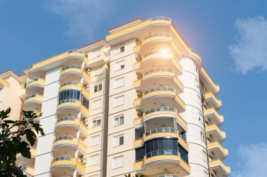 Low angle view of an apartment building with balconies. Residential real estate.