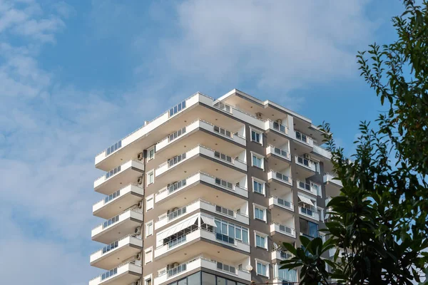 Low angle view of an apartment building with balconies. Residential real estate.