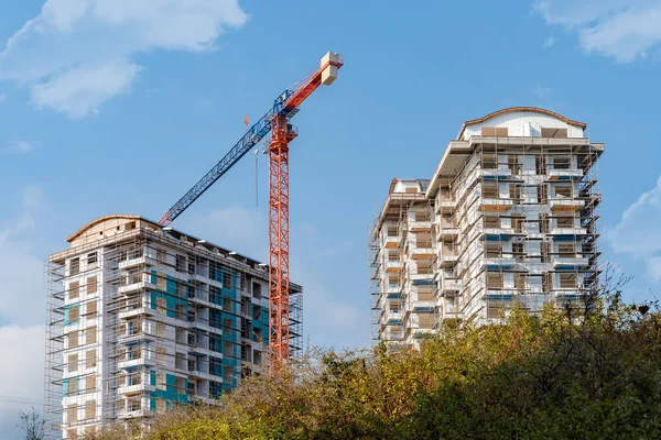 Construction of a monolithic residential building in Alanya. Construction site with a crane.