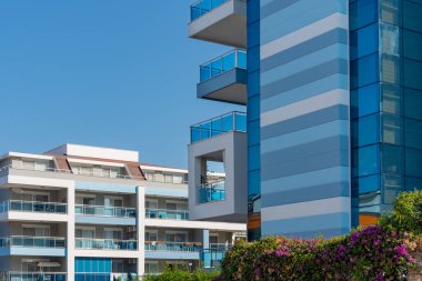 Cityscape of a residential area with modern apartment buildings on a sunny day.