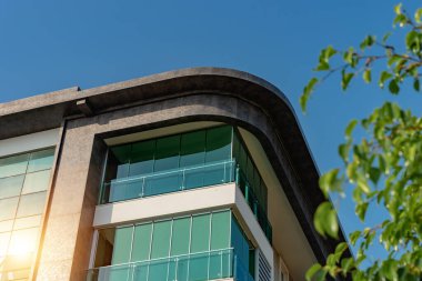 Image of the exterior of a residential building against a blue sky. Residential real estate in Turkey.