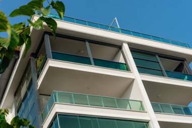 Image of the exterior of a residential building against a blue sky. Residential real estate in Turkey.