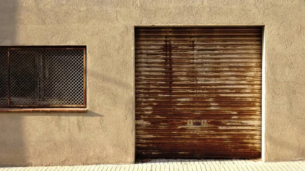 rusty roller door on the facade