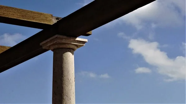 stone column construction against blue sky