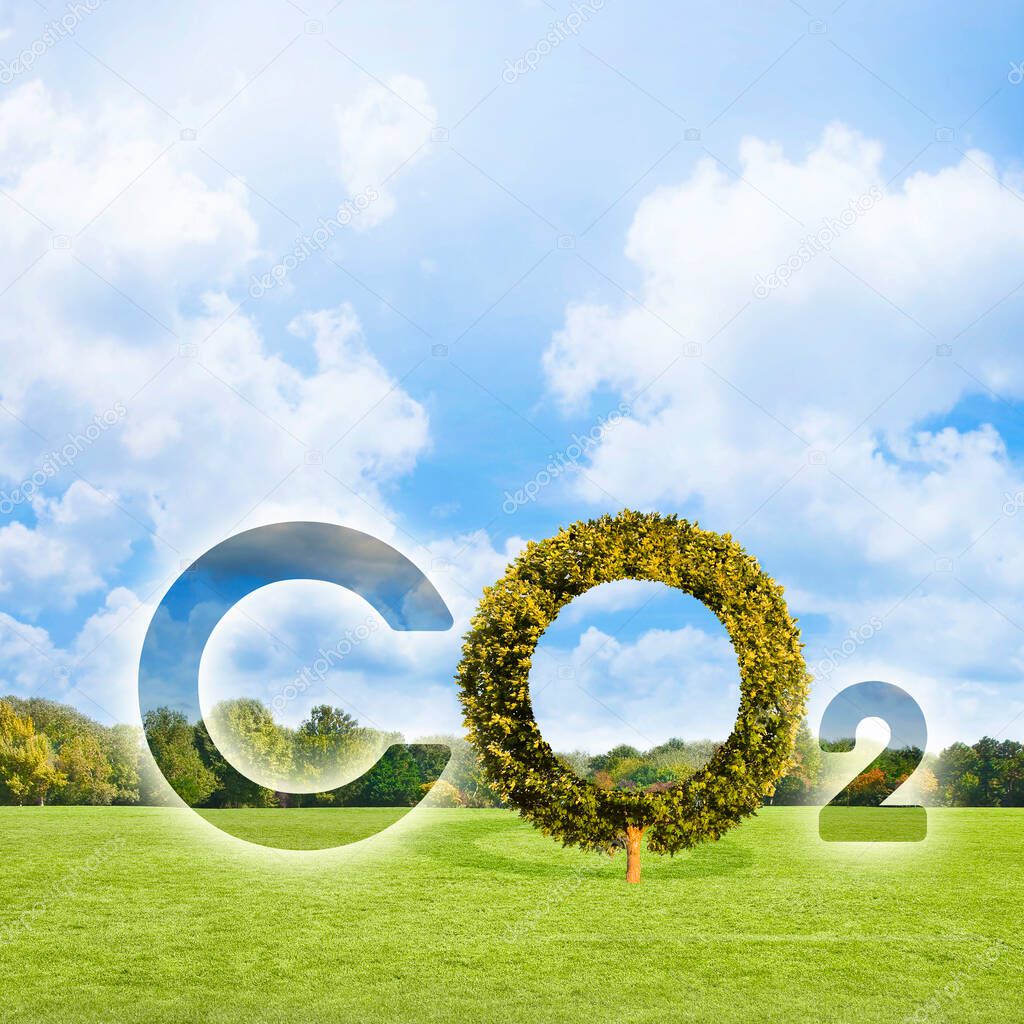 Reduction of the amount of CO2 emissions - concept with CO2 icon text and tree shape in rural scene with  green mowed lawn with trees and copy space