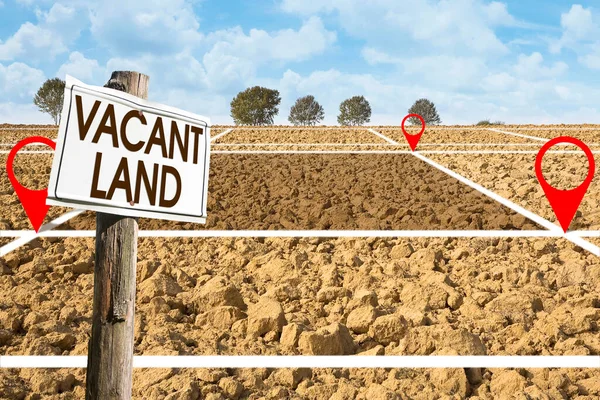Plowed field with signboard and Vacant Land text - Land plot management - Real estate concept with a vacant land available for residential buildings construction