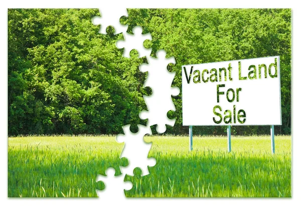 Advertising billboard in a rural scene with Vacant Land for Sale written on it - Real Estate solutions concept in jigsaw puzzle shape