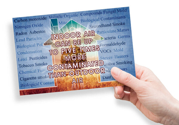 Indoor Air More Contaminated than Outdoor - concept with the most common dangerous domestic pollutants in our homes and hand holding a postcard