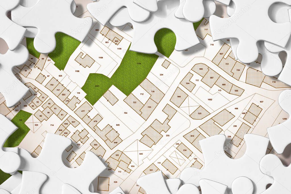 Imaginary cadastral map of territory with buildings, roads, land parcel and free green land available for building construction - concept image in jigsaw puzzle shape