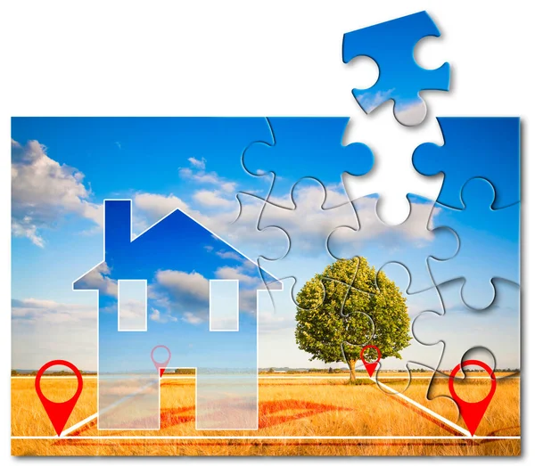 Land plot management - real estate solutions concept with a vacant land, lone tree on a wheat field available for building construction for sale with small house in jigsaw puzzle shape