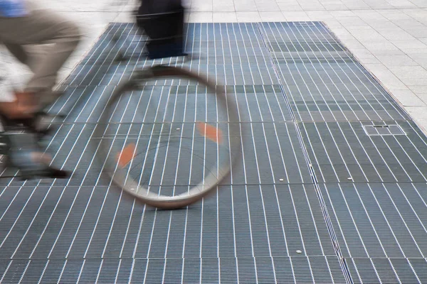 サイクリストが通過する都市部の新しい換気鉄格子 — ストック写真