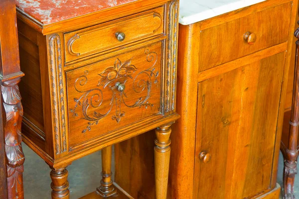 Antique italian wooden bedside table just restored with floral decorations.