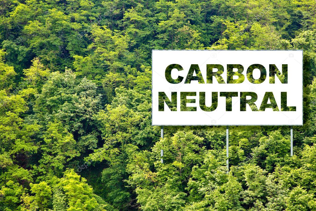 CO2 Carbon Neutral concept against an advertising billboard immersed in nature with forest in the background 