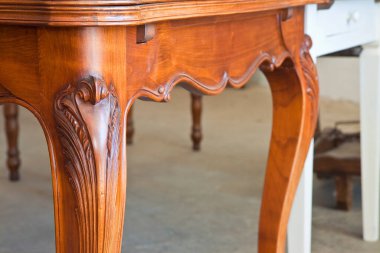 Detail of an old carved italian wooden table just restored