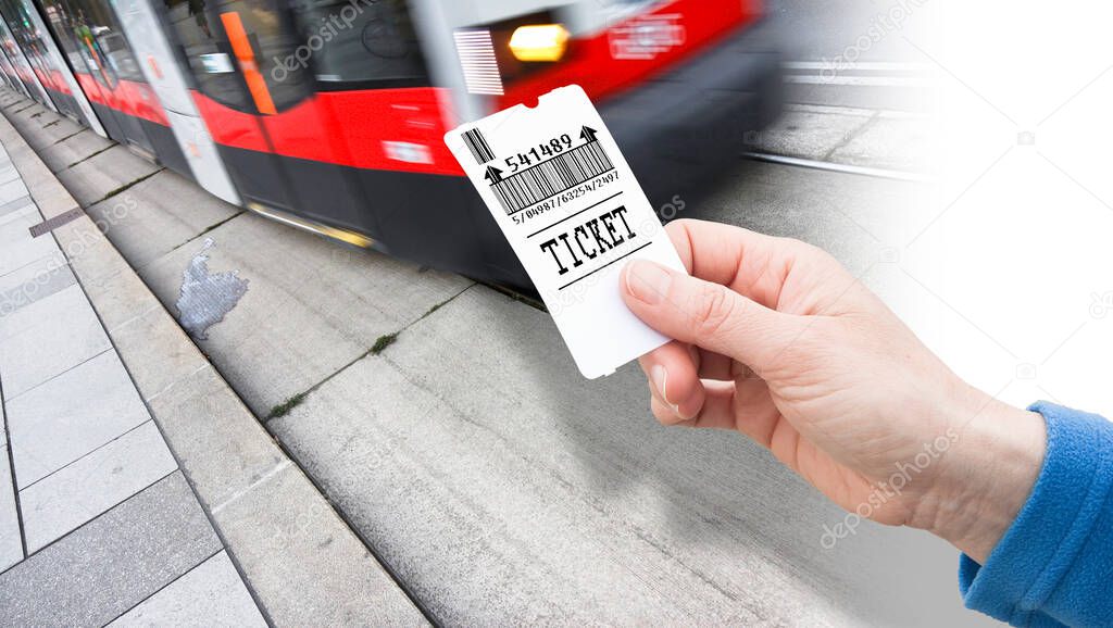 Hand holds a city tram ticket - payment concept with bus that is coming - Bar code and code numbers are completely made up