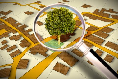 Cadastral map with a tree on a green area - Concept image seen through a magnifying glass. clipart