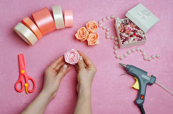 How to make a rose from a ribbon, fabric with your own hands .DIY crafts.Satin ribbons, stones,rhinestones,glue gun,scissors.Girl holding a rose made of ribbons in her hands.Step 8.Step by step