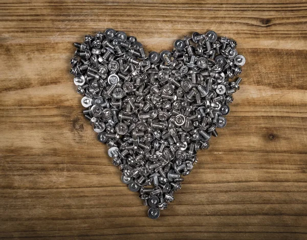 Eine Herzförmige Figur Aus Schrauben Auf Einem Braunen Holzbrett Konzept — Stockfoto