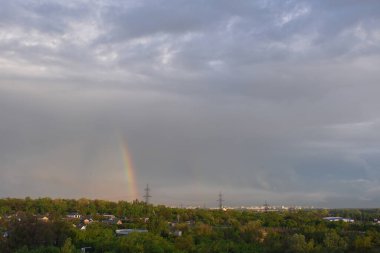 Orman ve gökkuşağı üzerinde kümülüs bulutları