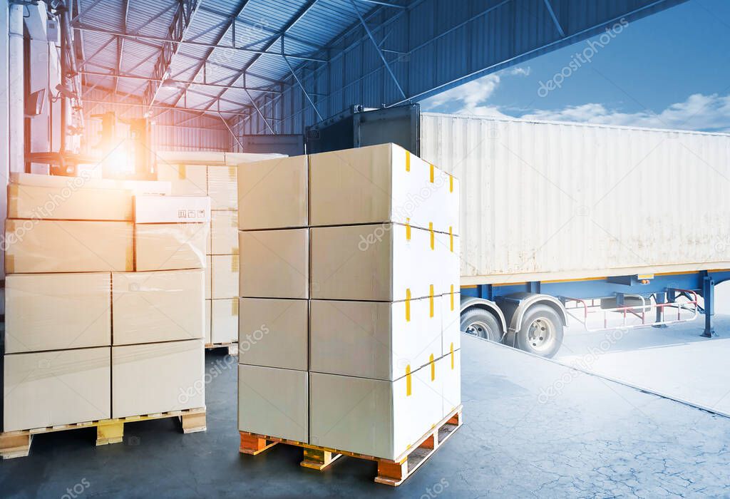 Packaging Boxes on Pallets Loading with Shipping Cargo Container. Truck Parked Loading at Dock Warehouse. Supply Chain Shipment Logistics. Cargo Freight Truck Transportation.