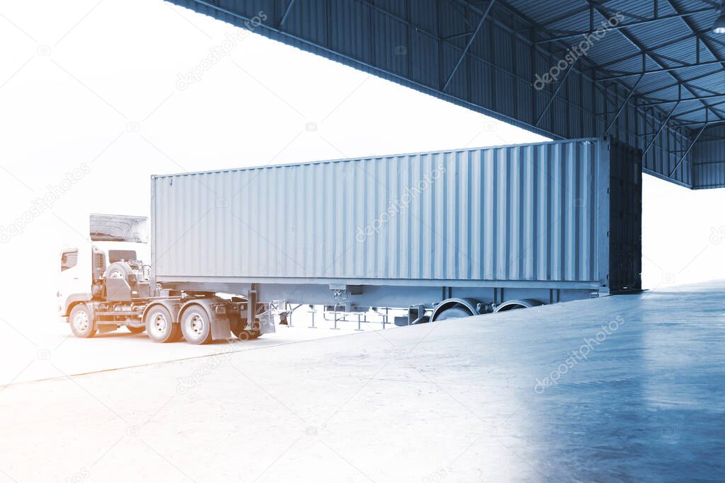 Semi Trailer Truck Parked Loading at Dock Warehouse. Cargo Container. Delivery Service. Industry Freight Truck Transportation. Shipping Warehouse Logistics