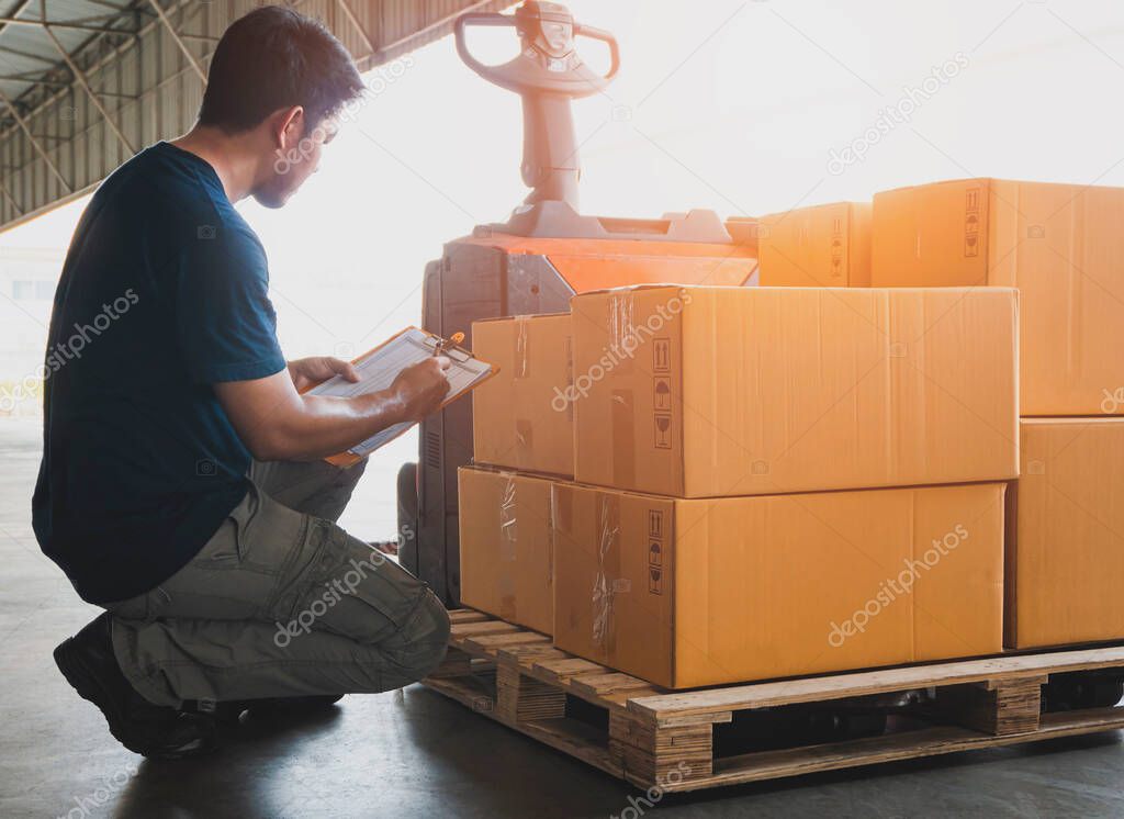 Asian Warehouse Worker Holding Clipboard his Doing Inventory Management. Cargo Shipment Checking Stock Packaging Boxes. Cargo Shipping Customers Service.