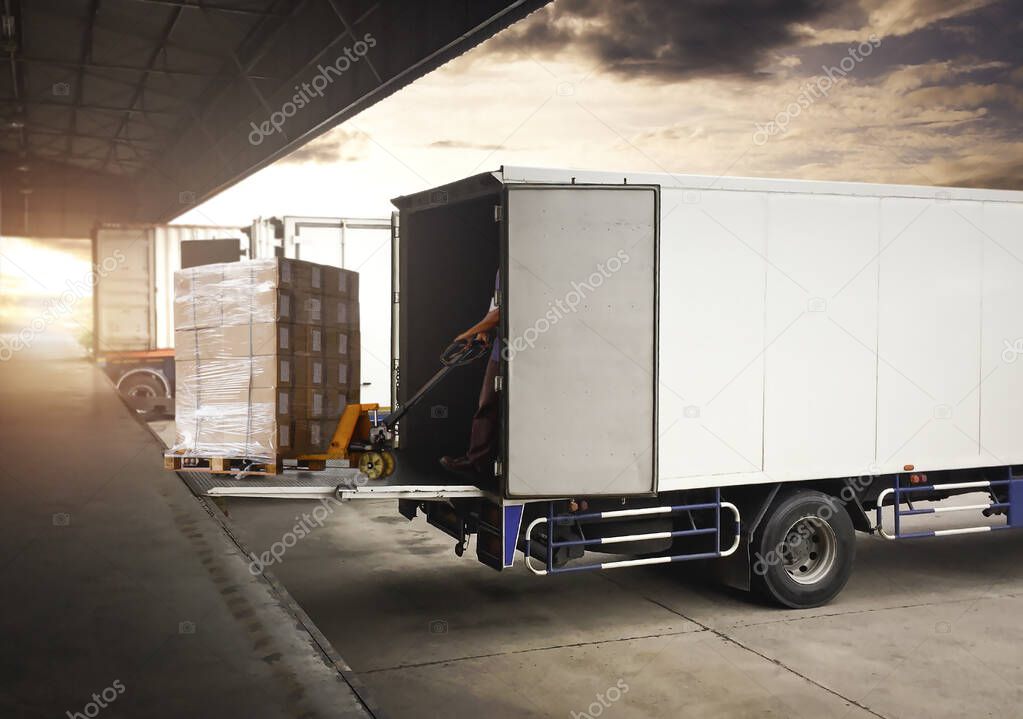 Workers Unloading Packaging Boxes on Pallet into Cargo Container. Delivery Trucks Shipment. Trucks Loading at Dock Warehouse. Supply Chain. Warehouse Shipping Transport and Logistics.
