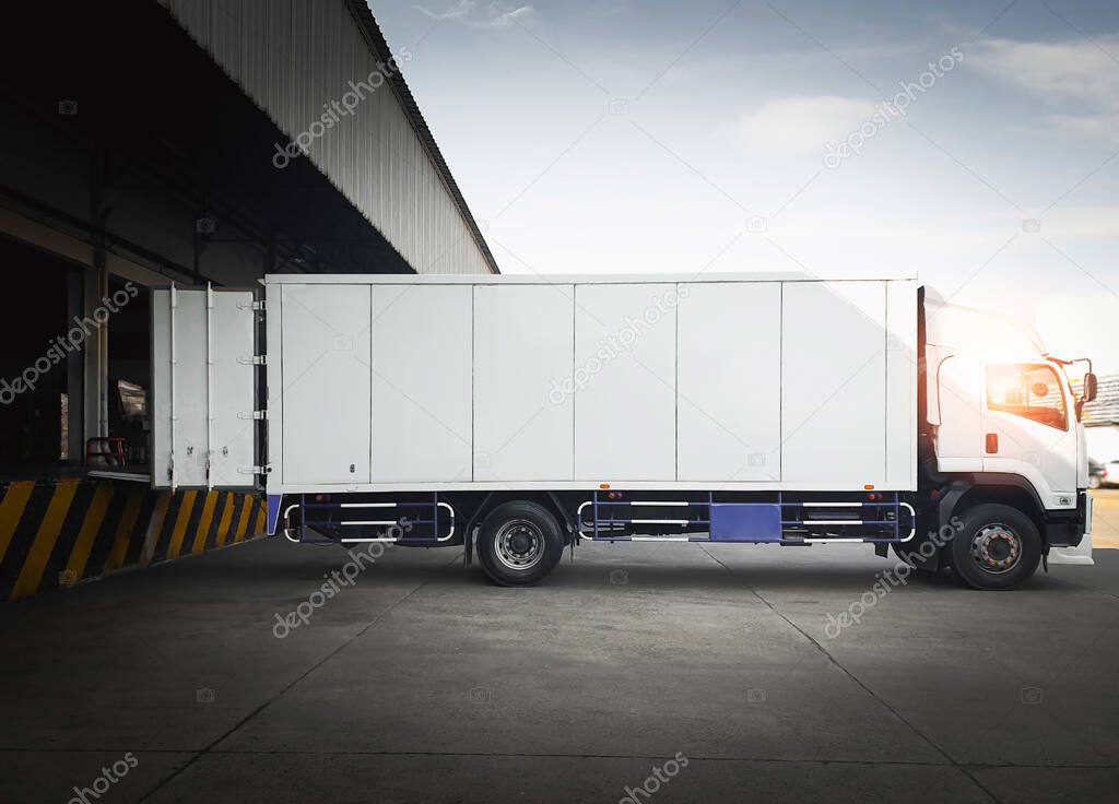 Cargo Container Trucks Parked Loading at Dock Warehouse. Shipping Cargo Trucks. Distribution Warehouse Center. Lorry. Industry Freight Trucks Transport Logistics.