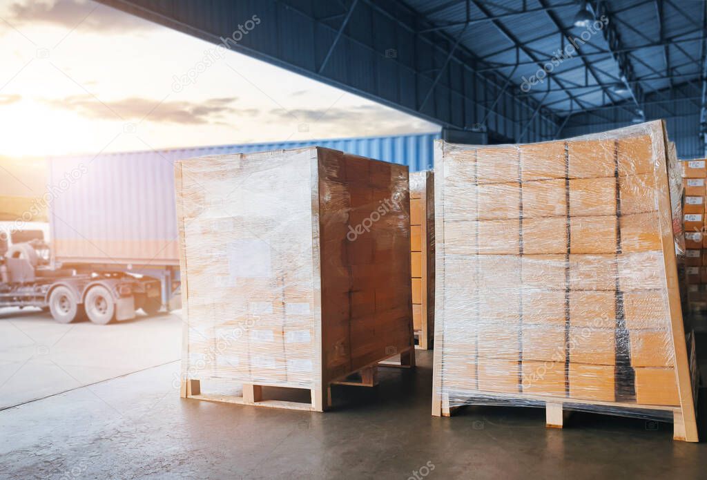 Packaging Boxes Stacked on Pallets Loading into Shipping Cargo Container. Delivery Trucks Parked Loading at Dock Warehouse. Supply Chain Customers Shipment Logistics. Cargo Freight Truck Transport