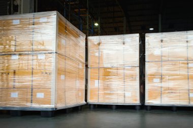 Packaging Boxes Stacked Wrapped Plastic on Plastic Pallets with L-shape Pallet Corrugated Paper Cardboard Angle Corner Edge Protector. Supply Chain. Shipment Goods. Shipping Warehouse Logistics.