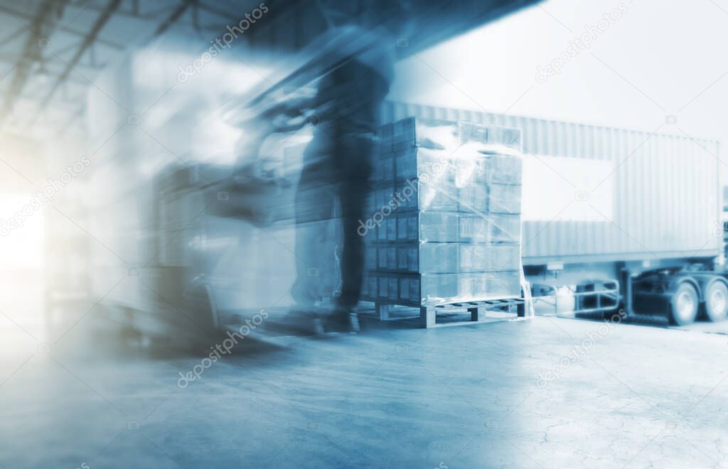 Fast Motion Blurred of Wokers Uloading Packaging Boxes on Pallets. ContainerTrucks Loading at Dock Warehouse. Shipments Supply Chain. Shipping Cargo Warehouse Logistics Transportation.