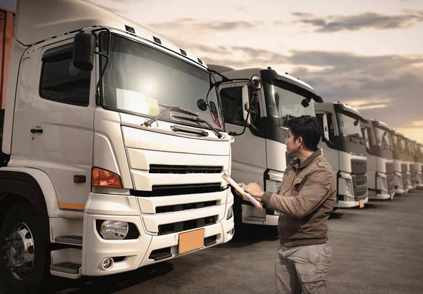 Truck Drivers Checking the Semi Truck's Maintenance Checklist. Inspection Safety Before Driving. Freight Truck Transport.