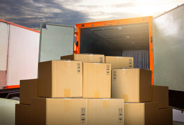 Packaging Boxes Stacked on Pallets Loading into Shipping Cargo Container. Loading Dock. Delivery Trucks. Supply Chain Distributions. Cargo Shipment. Freight Truck Transport. Logistics