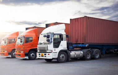 Semi TrailerTrucks Parked Lot with The Sunset Sky. Shipping Container. Delivery, Transit. Engine Diesel Trucks. Lorry Tractor. Industry Freight Trucks Logistics Cargo Transport.