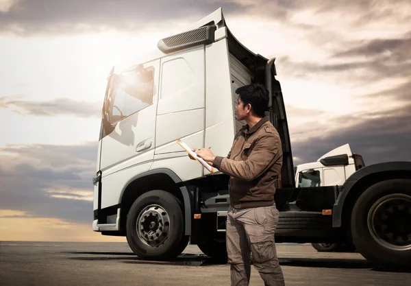 Truck Drivers Checking the Semi Truck's Maintenance Checklist. Inspection Safety Before Driving. Freight Truck Transport.