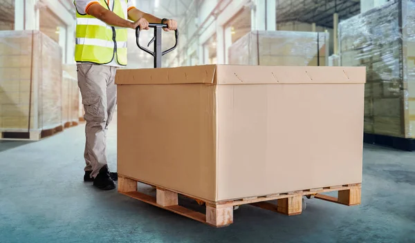 Workers Unloading Cargo Boxes on Pallets in Warehouse. Cartons Cardboard Boxes. Shipping Warehouse. Delivery. Shipment Goods. Supply Chain. Distribution Warehouse Logistics Cargo Transport.
